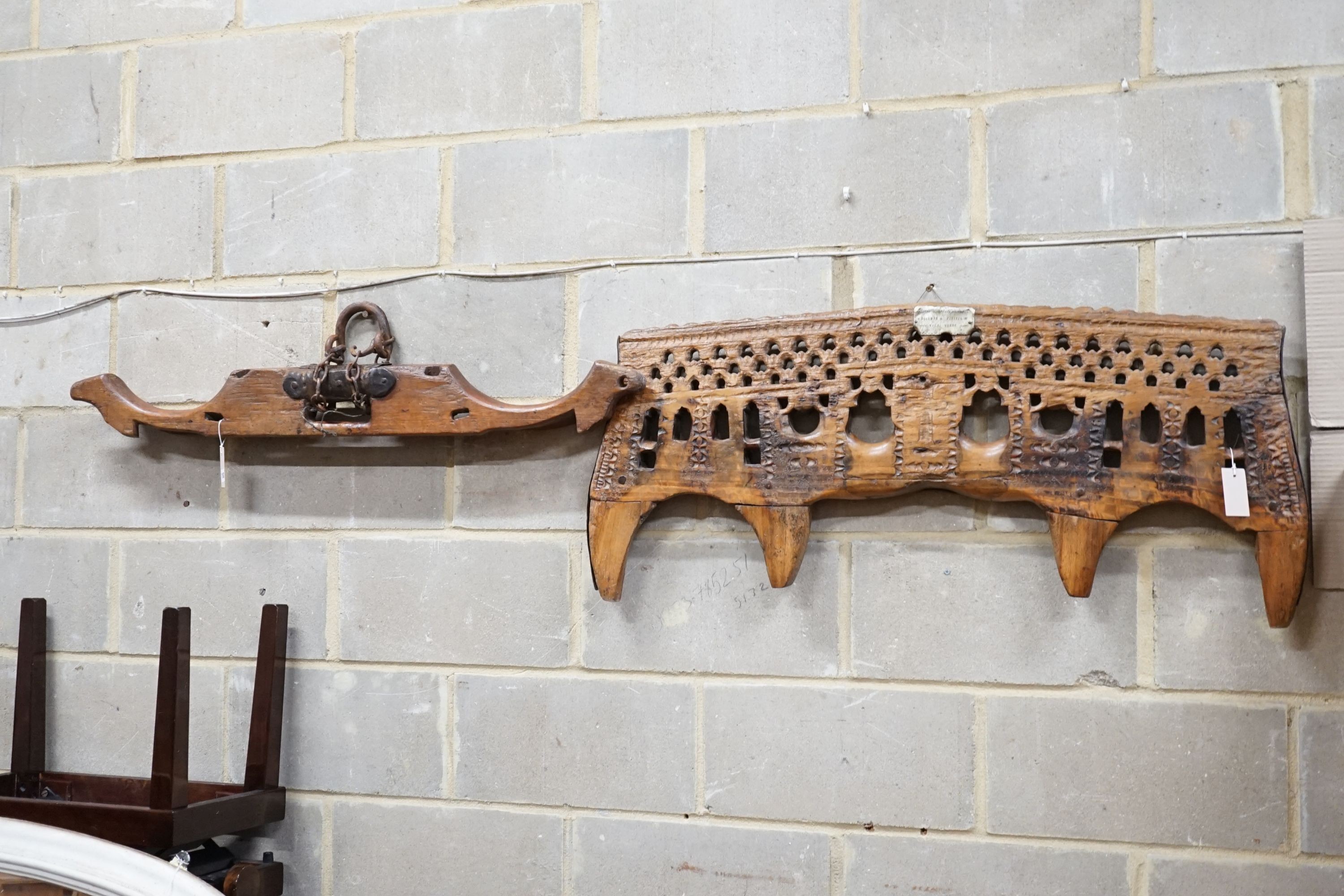 A carved hardwood ox yoke with plaque inscribed Antonio Gonzalez Vila Verde, width 110cm and another plainter yoke, width 111cm